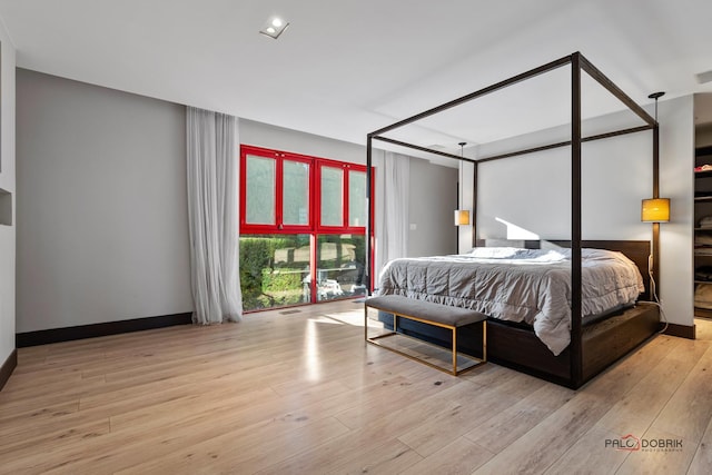 bedroom featuring wood finished floors and baseboards