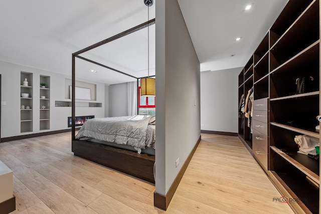 bedroom featuring recessed lighting, baseboards, and wood finished floors