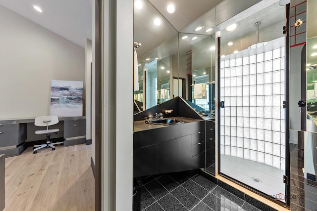 bathroom featuring recessed lighting, tiled shower, vanity, and granite finish floor