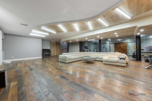 living room with visible vents, baseboards, and wood-type flooring