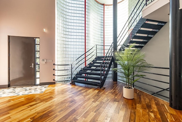 foyer featuring stairway and wood finished floors