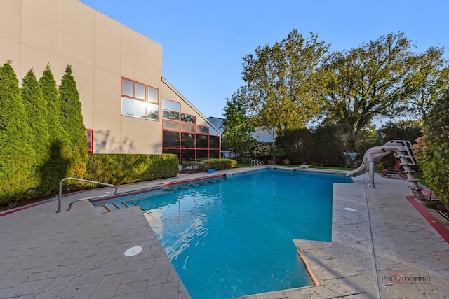outdoor pool featuring a patio and a water slide