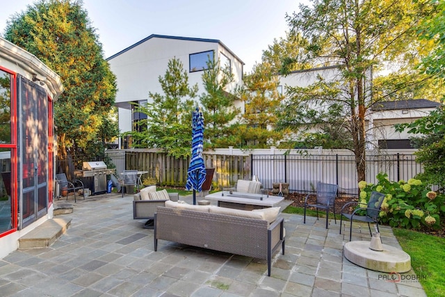 view of patio / terrace with an outdoor living space, a grill, and fence