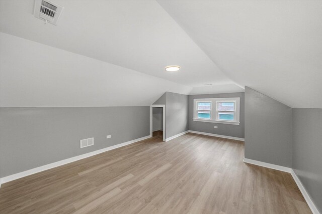 3012 N Knox Ave, Chicago, IL 60641 - bonus room featuring visible vents, baseboards, wood finished floors, and vaulted ceiling