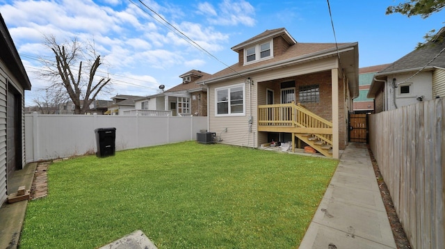 3012 N Knox Ave, Chicago, IL 60641 - rear view of house featuring roof with shingles, a fenced backyard, central AC, a lawn, and brick siding