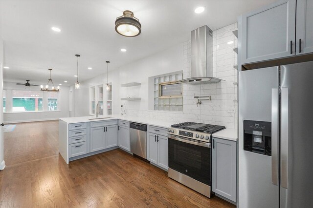 3012 N Knox Ave, Chicago, IL 60641 - kitchen with wall chimney range hood, dark wood finished floors, light countertops, appliances with stainless steel finishes, and a sink