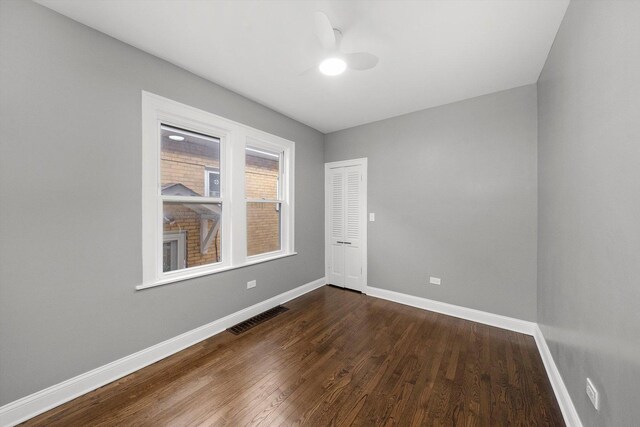3012 N Knox Ave, Chicago, IL 60641 - empty room featuring visible vents, baseboards, dark wood-style floors, and ceiling fan