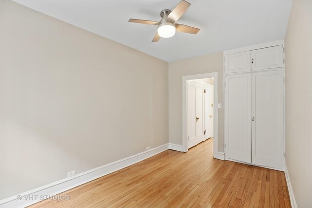 unfurnished bedroom with light wood-style flooring, a closet, ceiling fan, and baseboards