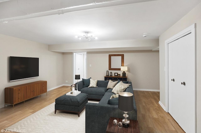 living area with light wood-type flooring and baseboards