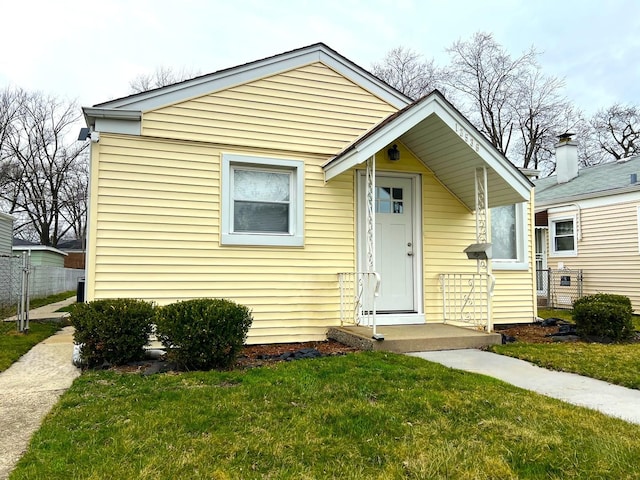 bungalow-style house with a front yard