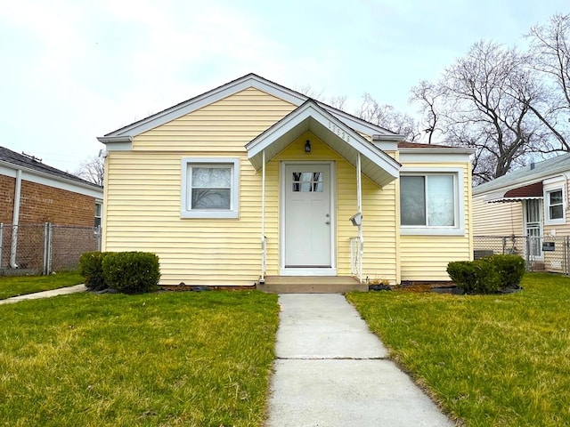 bungalow with fence and a front yard