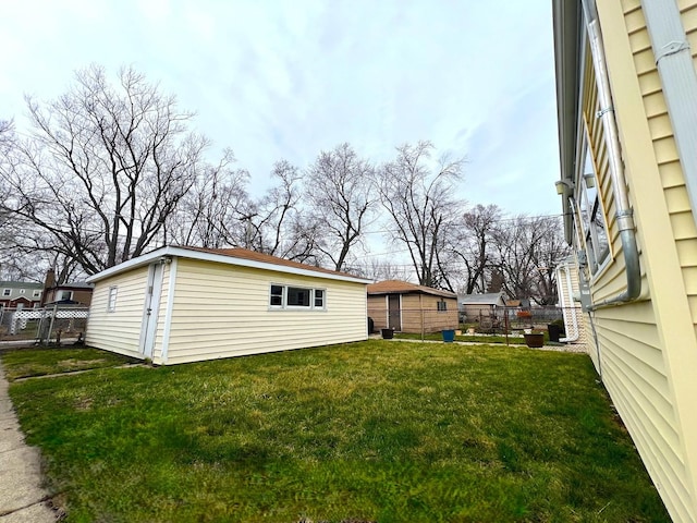 view of yard with an outbuilding and fence