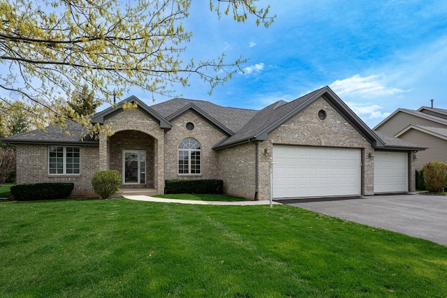 view of front facade featuring a shingled roof, an attached garage, brick siding, aphalt driveway, and a front yard
