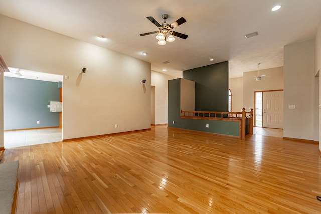 unfurnished living room featuring visible vents, baseboards, recessed lighting, a ceiling fan, and light wood finished floors