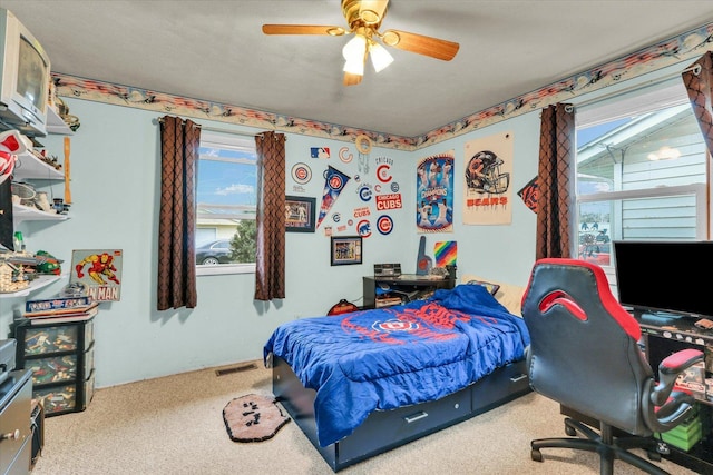carpeted bedroom featuring visible vents and a ceiling fan