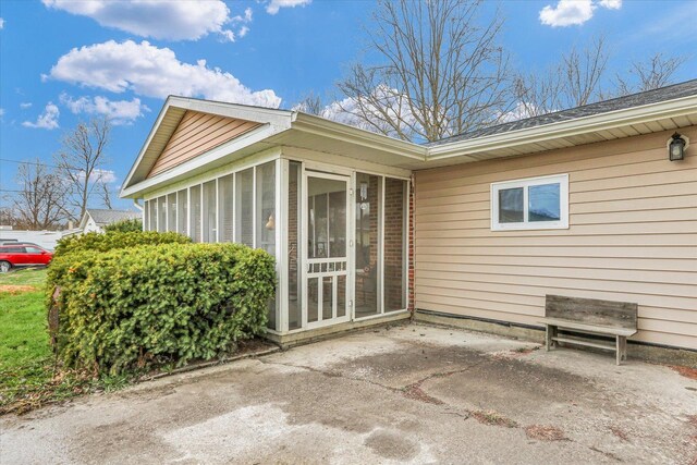 exterior space with a sunroom and a patio area