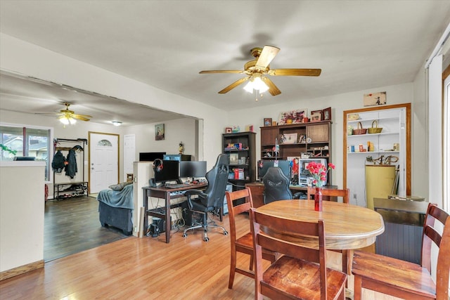 dining space featuring light wood-style flooring and a ceiling fan