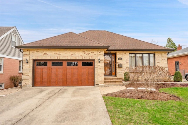 view of front facade featuring roof with shingles, brick siding, driveway, and an attached garage