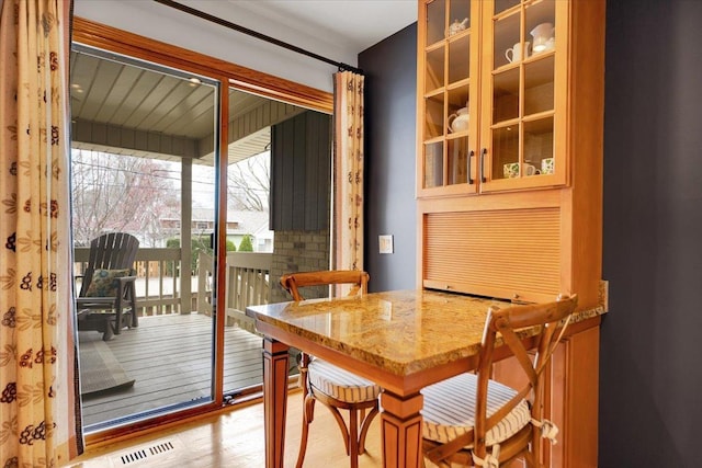 dining area with visible vents and wood finished floors
