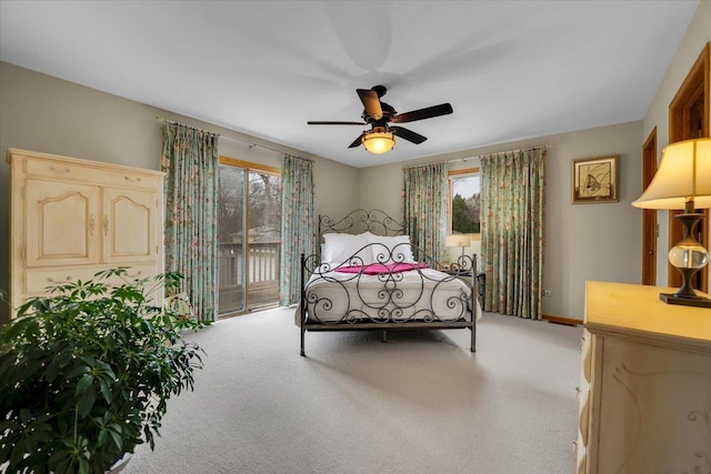 carpeted bedroom featuring access to exterior, baseboards, and a ceiling fan