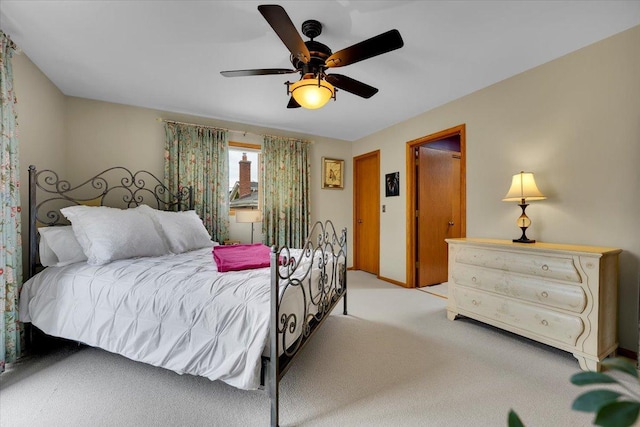 bedroom featuring a ceiling fan and light carpet
