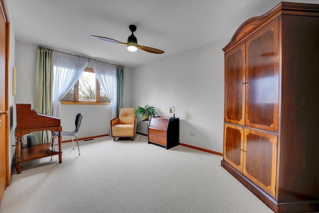 living area with carpet, visible vents, baseboards, and a ceiling fan