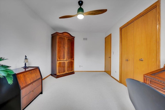 interior space featuring light carpet, ceiling fan, baseboards, and visible vents