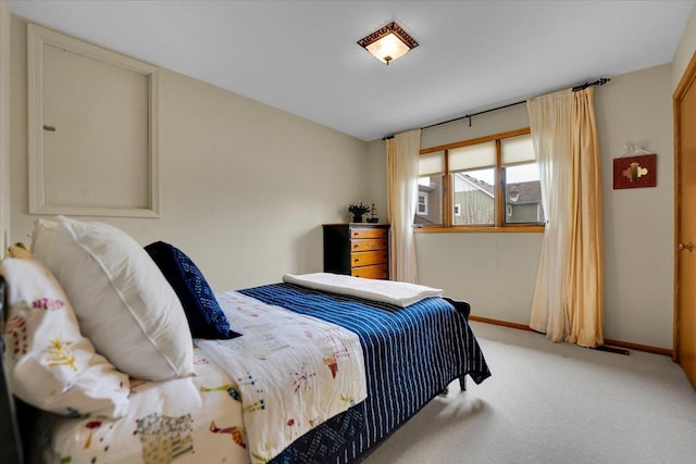 bedroom featuring light colored carpet and baseboards