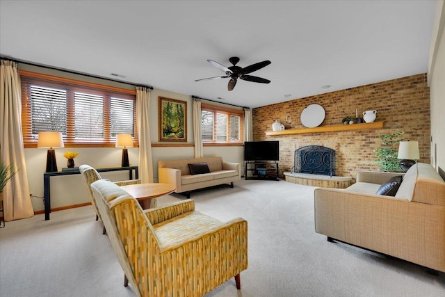 carpeted living room featuring visible vents, ceiling fan, brick wall, and a fireplace