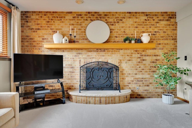 living area featuring a fireplace and carpet floors