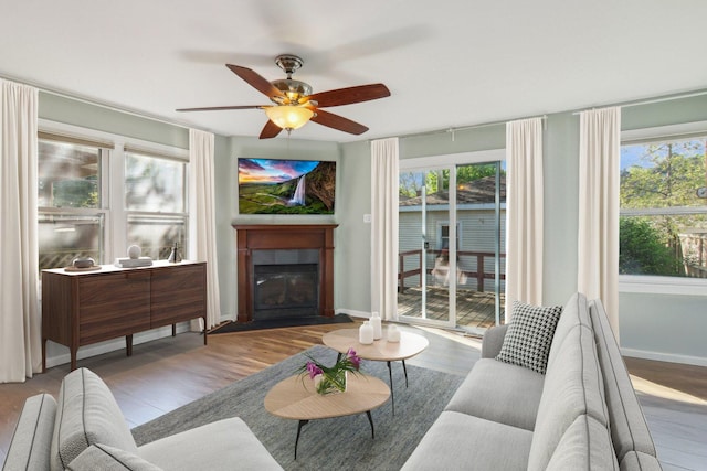 5842 N Kingsdale Ave, Chicago, IL 60646 - living room featuring wood finished floors, baseboards, a ceiling fan, and a fireplace with flush hearth