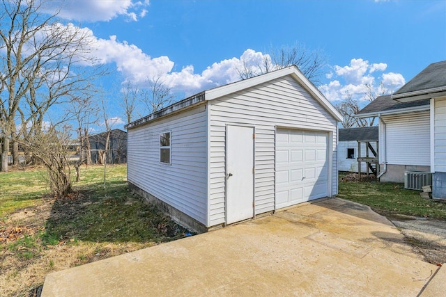 detached garage with cooling unit and driveway