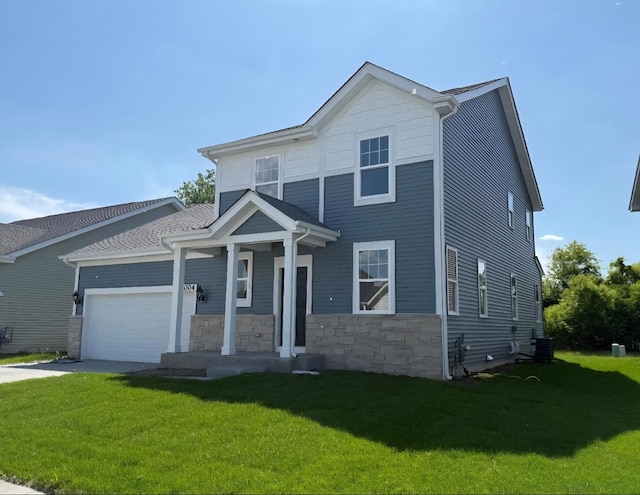 32004 Savannah Dr, Lakemoor, IL 60051 - view of front facade featuring a front lawn, a garage, driveway, and stone siding
