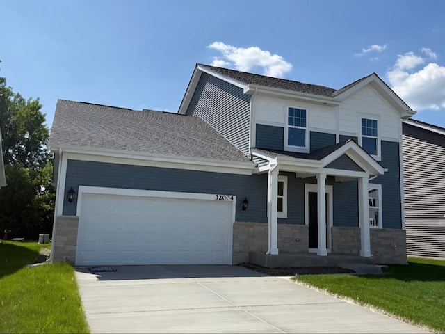 32004 Savannah Dr, Lakemoor, IL 60051 - view of front of house with a porch, an attached garage, stone siding, concrete driveway, and a shingled roof