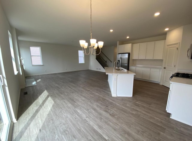 32004 Savannah Dr, Lakemoor, IL 60051 - kitchen featuring stainless steel fridge with ice dispenser, a chandelier, wood finished floors, open floor plan, and light countertops