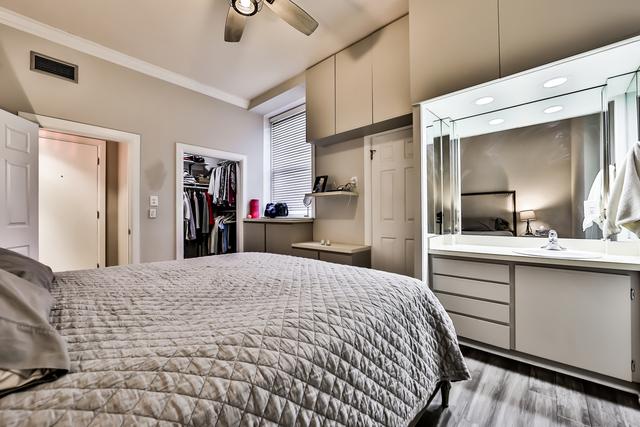 1500 N Lasalle Dr Unit 5B, Chicago, IL 60610 - bedroom featuring visible vents, a closet, a sink, crown molding, and wood finished floors