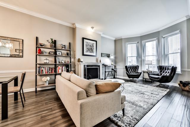 1500 N Lasalle Dr Unit 5B, Chicago, IL 60610 - living area with dark wood-type flooring, a fireplace, baseboards, and ornamental molding