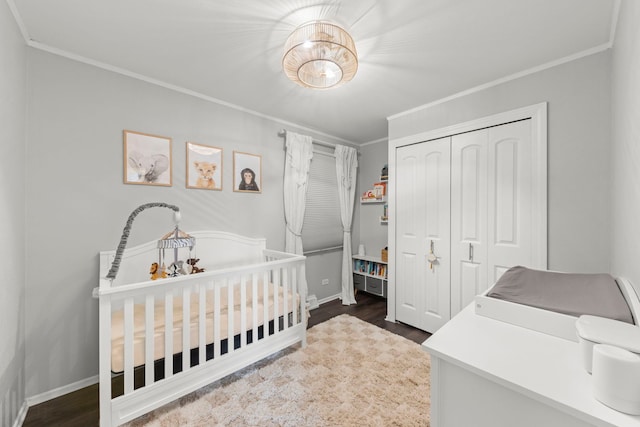 4N210 Norris Ave, West Chicago, IL 60185 - bedroom featuring dark wood finished floors, a crib, a closet, crown molding, and baseboards