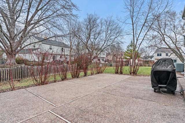 view of patio featuring central AC unit and fence