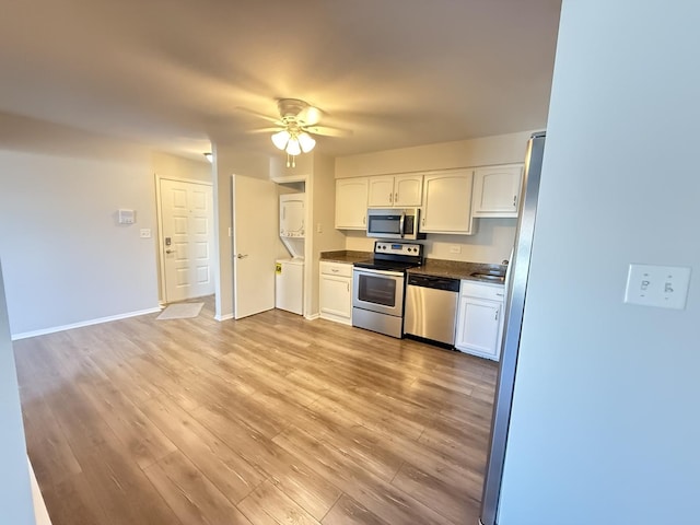 2356 Gaylord Rd Unit 2D, Crest Hill, IL 60403 - kitchen featuring stainless steel appliances, stacked washer / dryer, dark countertops, and white cabinets