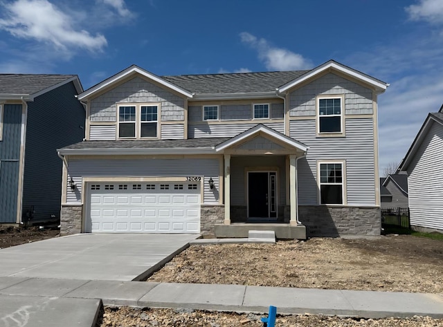 32069 Savannah Dr, Lakemoor, IL 60051 - view of front of home featuring a garage, concrete driveway, roof with shingles, and stone siding
