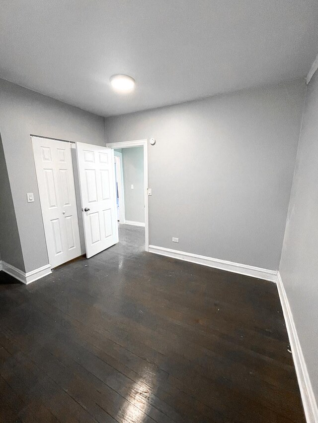 6634 S Greenwood Ave Unit 3B, Chicago, IL 60637 - unfurnished bedroom featuring baseboards and dark wood-style floors