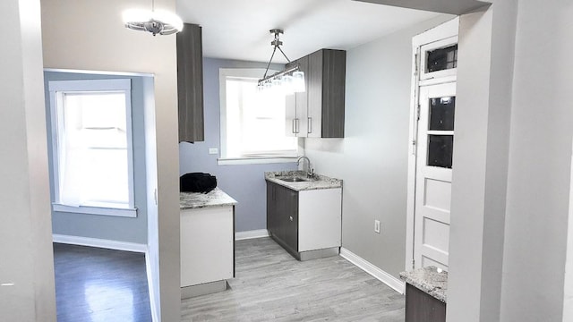 6634 S Greenwood Ave Unit 3B, Chicago, IL 60637 - kitchen featuring light wood-style flooring, baseboards, and a sink