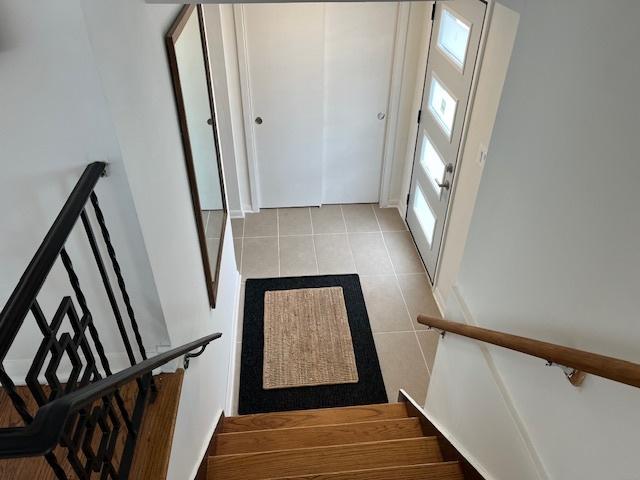 8944 S Maple Ln, Hickory Hills, IL 60457 - staircase featuring plenty of natural light and tile patterned floors