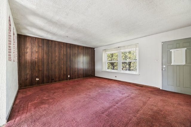 17433 Appletree Dr, Hazel Crest, IL 60429 - unfurnished room featuring a textured ceiling, wooden walls, and carpet