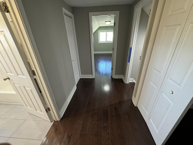 hall with hardwood / wood-style floors and baseboards