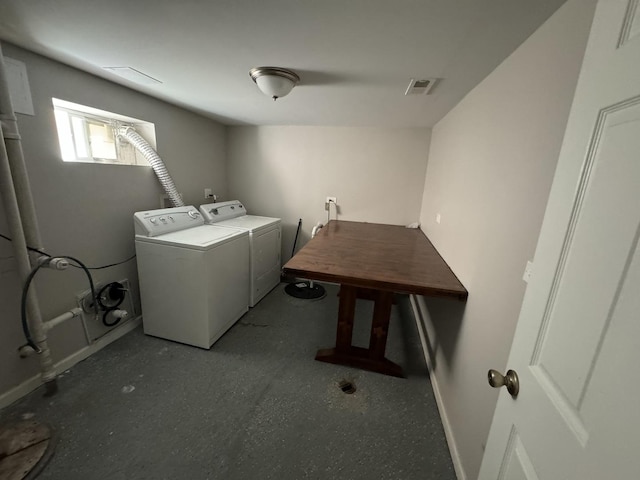 laundry area with baseboards, visible vents, and washing machine and clothes dryer