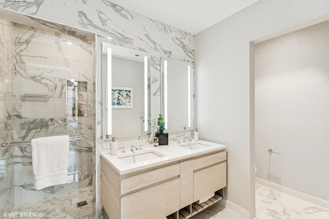 full bathroom featuring marble finish floor, a sink, a marble finish shower, and double vanity