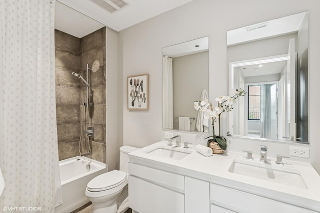 full bathroom with visible vents, a sink, double vanity, and toilet
