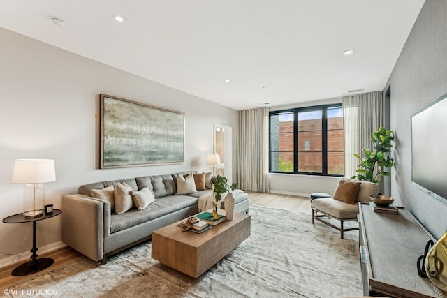 living room with light wood-style flooring and baseboards